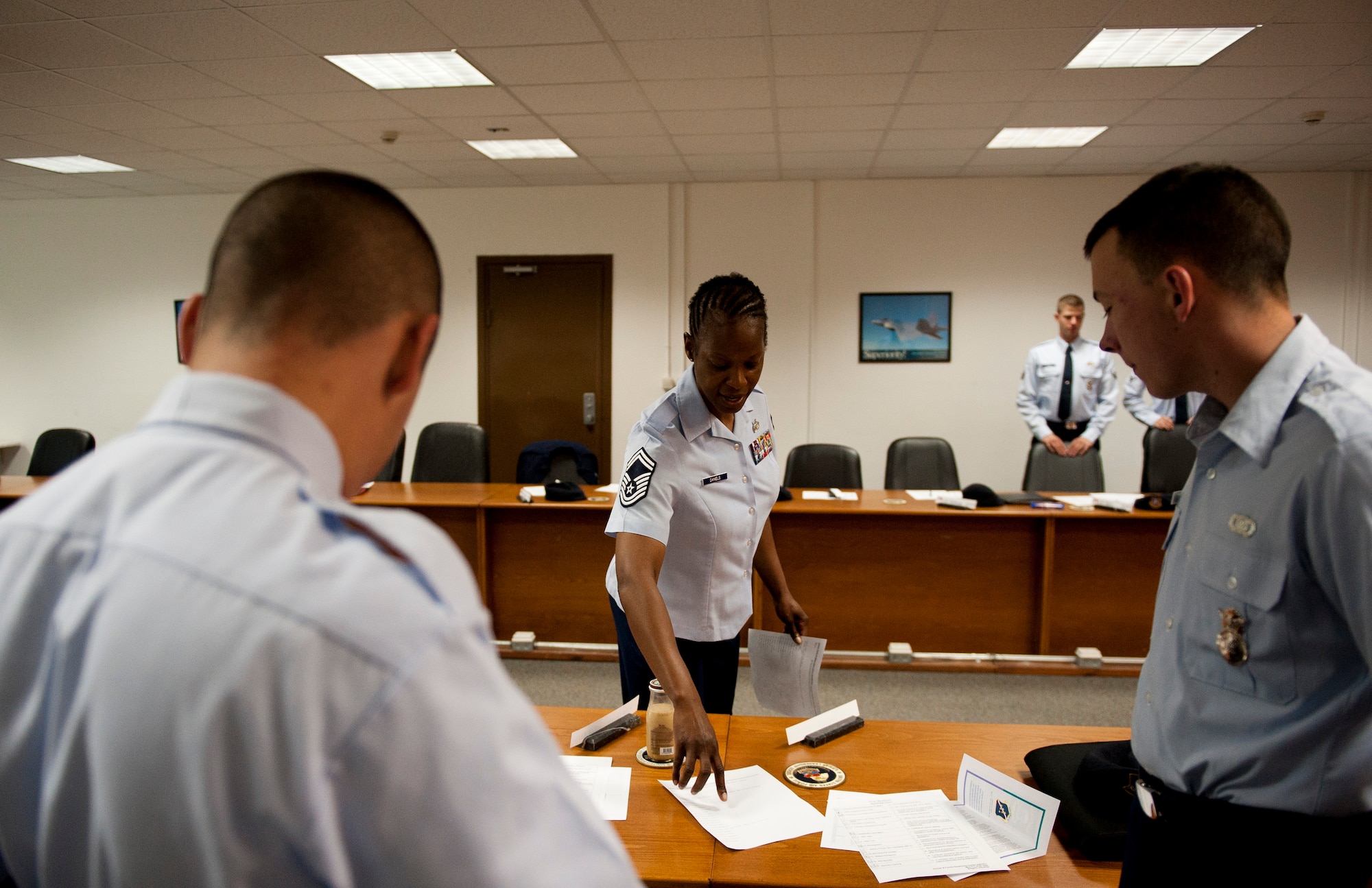 Senior Master Sgt. Ouida Daniels, 39th Force Support Squadron career advisor, center, helps an Airman fill out paperwork prior to briefing a group of first-term Airmen April 9, 2012, at Incirlik Air Base, Turkey. As the career advisor, Daniels assists Incirlik Airmen by helping find special duties in their career fields, explaining how cross training works and the eligibility requirements to cross train, relaying the options one has when separating from the Air Force, and showing where to find information on writing resumes and other skills. (U.S. Air Force photo by Senior Airman William A. O'Brien/Released) 