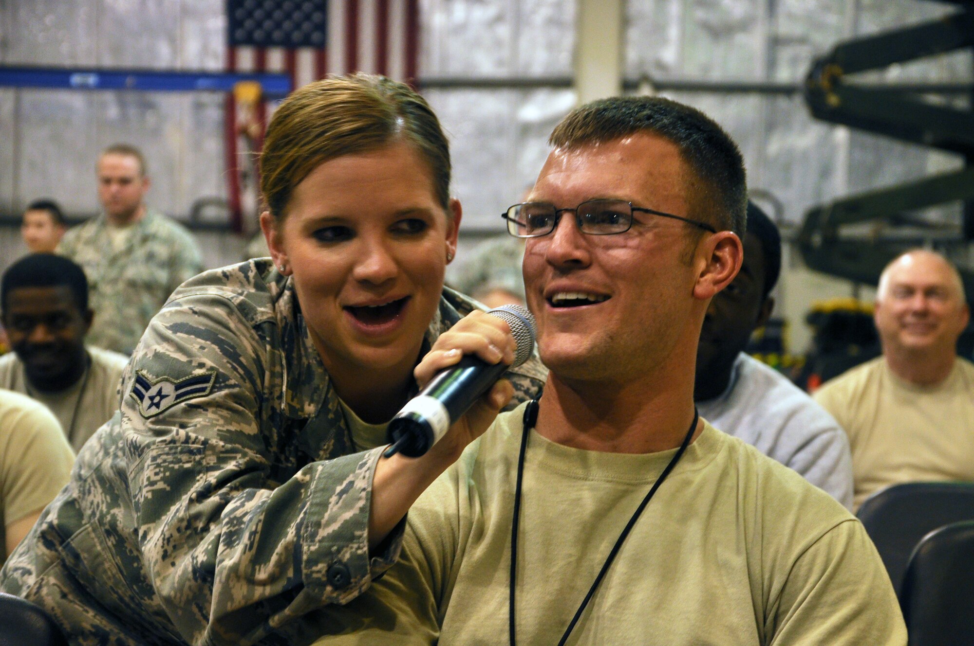 SOUTHWEST ASIA  - Airman 1st Class Melissa Rager, lead singer for Night Wing, the U.S. Air Forces Central Band, helps Staff Sgt. Samuel Jaks sing along during a performance at the 380th Air Expeditionary Wing April 8, 2012. Jaks, a Tallahassee, Fla., native is deployed from Mountain Home Air Force Base, Idaho. (U.S. Air Force photo/1st Lt. Victoria Porto)