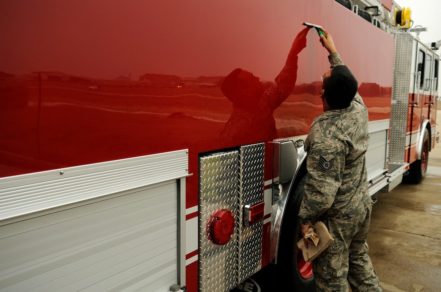 An 8th Civil Engineer Squadron firefighter from the Kunsan Air Base Fire Department cleans the side of a new fire truck on Kunsan Air Base, Republic of Korea, April 9, 2012. The Wolf Pack recently received two brand-new fire engines, which will assist the fire department in responding to structural fires on Kunsan Air Base. (U.S. Air Force photo/Senior Airman Jessica Hines) 