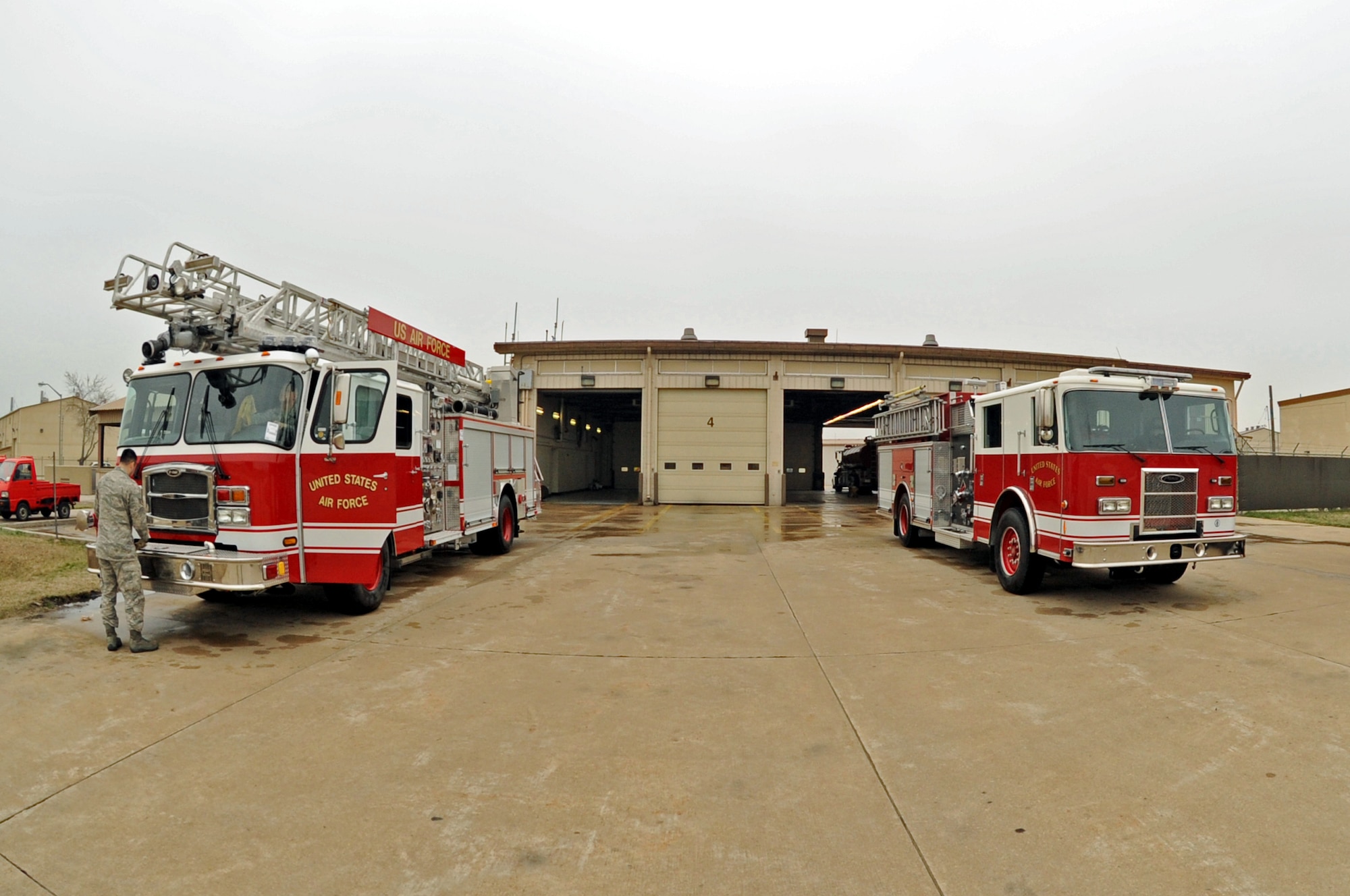 Two new fire trucks sit outside the Kunsan Air Base Fire Department before a ceremony, which Airmen later pushed into the station, April 9, 2012. The Wolf Pack recently received the new trucks, which will replace older ones that are between 15 to 25 years old. (U.S. Air Force photo/Senior Airman Jessica Hines) 