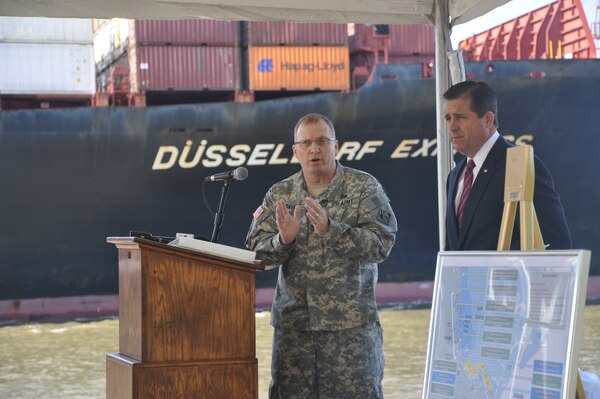 GEORGIA — Col. Jeff M. Hall, commander of the U.S. Army Corps of Engineers Savannah District, speaks at a press conference announcing the release of the Final Report for the Savannah Harbor Expansion Project, April 11, 2012. Pictured right is Curtis Foltz, executive director for the Georgia Ports Authority, who also attended and spoke at the press conference. In the background, a cargo ship sails up the Savannah River toward the Garden City Terminal. The event took place at the Corps' maintenance depot located on the Hutchinson Island side of the Savannah River.