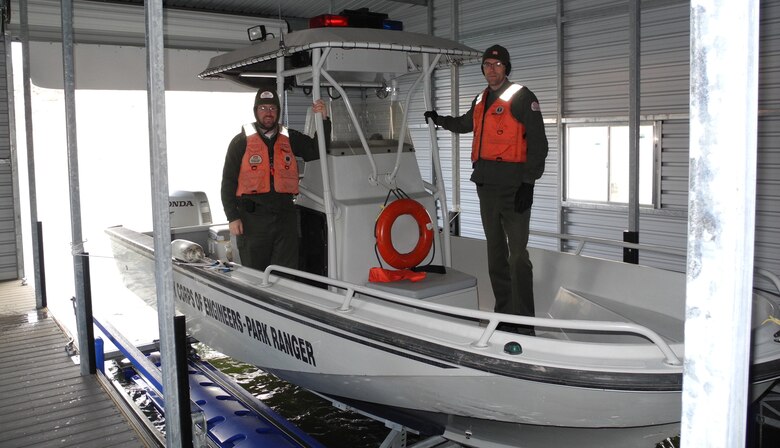 COCHITI LAKE, N.M. - Park Rangers Chris Schooley (left) and Nicholas Parks situate the Cochiti Lake Project’s boat in the dock.