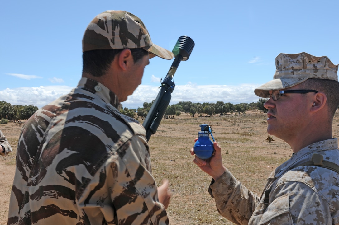 Lance Cpl. Grey J. Thurman, a military police officer of the 47th Marine Wing Support Group, 4th platoon, gives instructions to a Moroccan soldier during peace support operations training during African Lion 2012, April, 7-18. African Lion is an annual, bilateral training exercise between U.S. and Moroccan forces promoting interoperability and security cooperation.::r::::n::::r::::n::::r::::n::