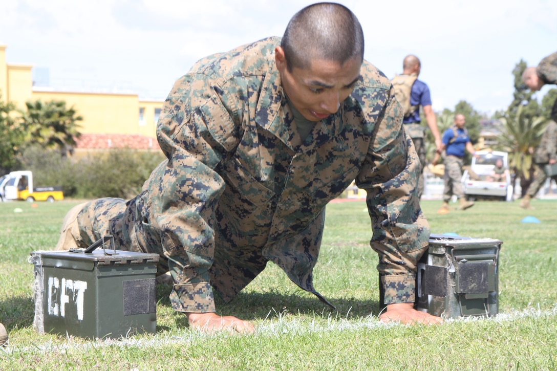 Company L recruit performs three push-ups during the Maneuver Under Fire portion of the Combat Fitness Test April 12 aboard Marine Corps Recruit Depot San Diego. Maneuver Under Fire is one test of three that make up the CFT. After throwing the simulated gernade the recruits have to do three push-ups and then run back with ammunition cans to the starting point.