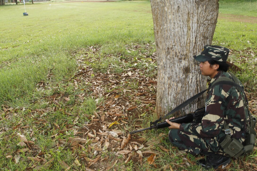 Armed Forces of the Philippines Air Force Staff Sgt. Mary Grace, a member of the 5711 Security Forces Squadron, provides security as explosive ordinance disposal technicians from Marine Wing Support Squadron 172 investigate a fake improvised explosive device during a training evolution as a part of Exercise Balikatan 2012 (BK12) on April 13, 2012 at the AFP's Western Command Base in Puerto Princesa, Palawan, Republic of the Philippines. BK12, in its 28th iteration, is an annual bilateral training exercise between the Republic of the Philippines and U.S. military members designed to build joint planning, contingency, humanitarian and disaster relief capabilities. MWSS-172 is part of Marine Wing Support Group 17, 1st Marine Aircraft Wing, III Marine Expeditionary Force. BK12 officially begins April 16, 2012.
