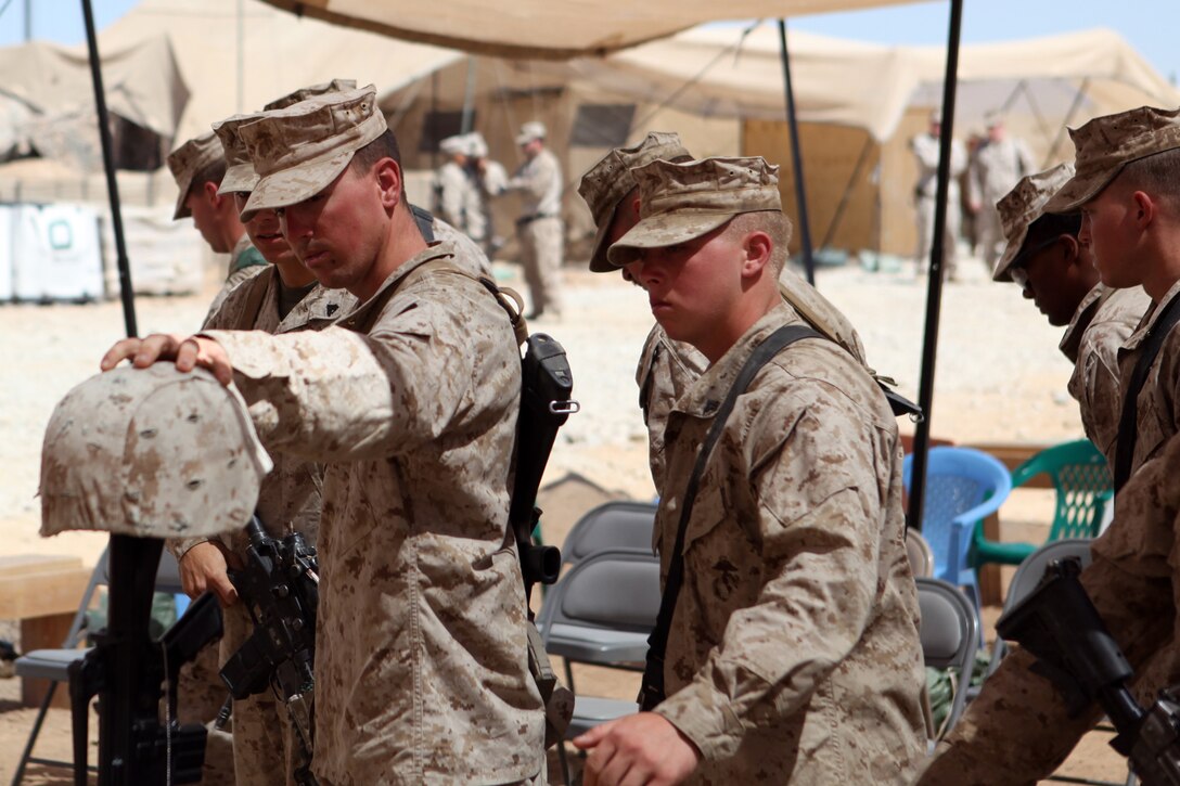 Marines with Echo Company, 2nd Battalion, 5th Marine Regiment honor fallen hero Cpl. Alex Martinez, during a memorial ceremony, April 13, 2012. Martinez was a combat engineer with 1st Combat Engineer Battalion, 1st Marine Division (Forward) and was deployed in support of 2nd Battalion, 5th Marine Regiment. He was killed in action April 5 while conducting combat operations in Now Zad District. During the ceremony Marines spoke about the man and Marine that Martinez was and what they would remember most about him. (Official Marine Corps photo by Lance Cpl. Mark Garcia)