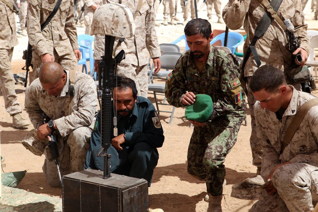 Marines along with their Afghan National Security Force partners honor fallen hero Cpl. Alex Martinez, during a memorial ceremony, April 13, 2012. Martinez was a combat engineer with 1st Combat Engineer Battalion, 1st Marine Division (Forward) and was deployed in support of 2nd Battalion, 5th Marine Regiment. He was killed in action April 5 while conducting combat operations in Now Zad District. During the ceremony, Marines spoke about the man and Marine that Martinez was and what they would remember most about him. (Official U.S. Marine Corps photo by Lance Cpl. Mark Garcia)