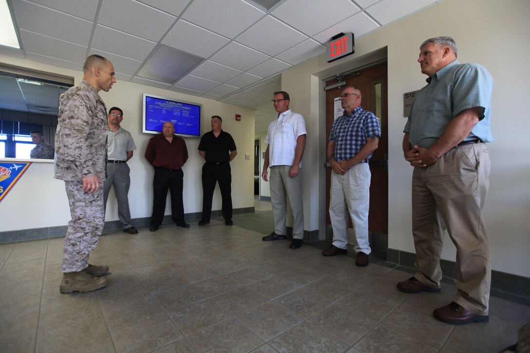 Brig. Gen. Thomas Gorry, Marine Corps Installation East commanding general, commends members of the Air::r::::n::Station Safety office for winning the Marine Corps Achievement in Safety Award, April 13. Representatives from::r::::n::the Air Station accepted the award in Washington, D.C. in late March::r::::n::