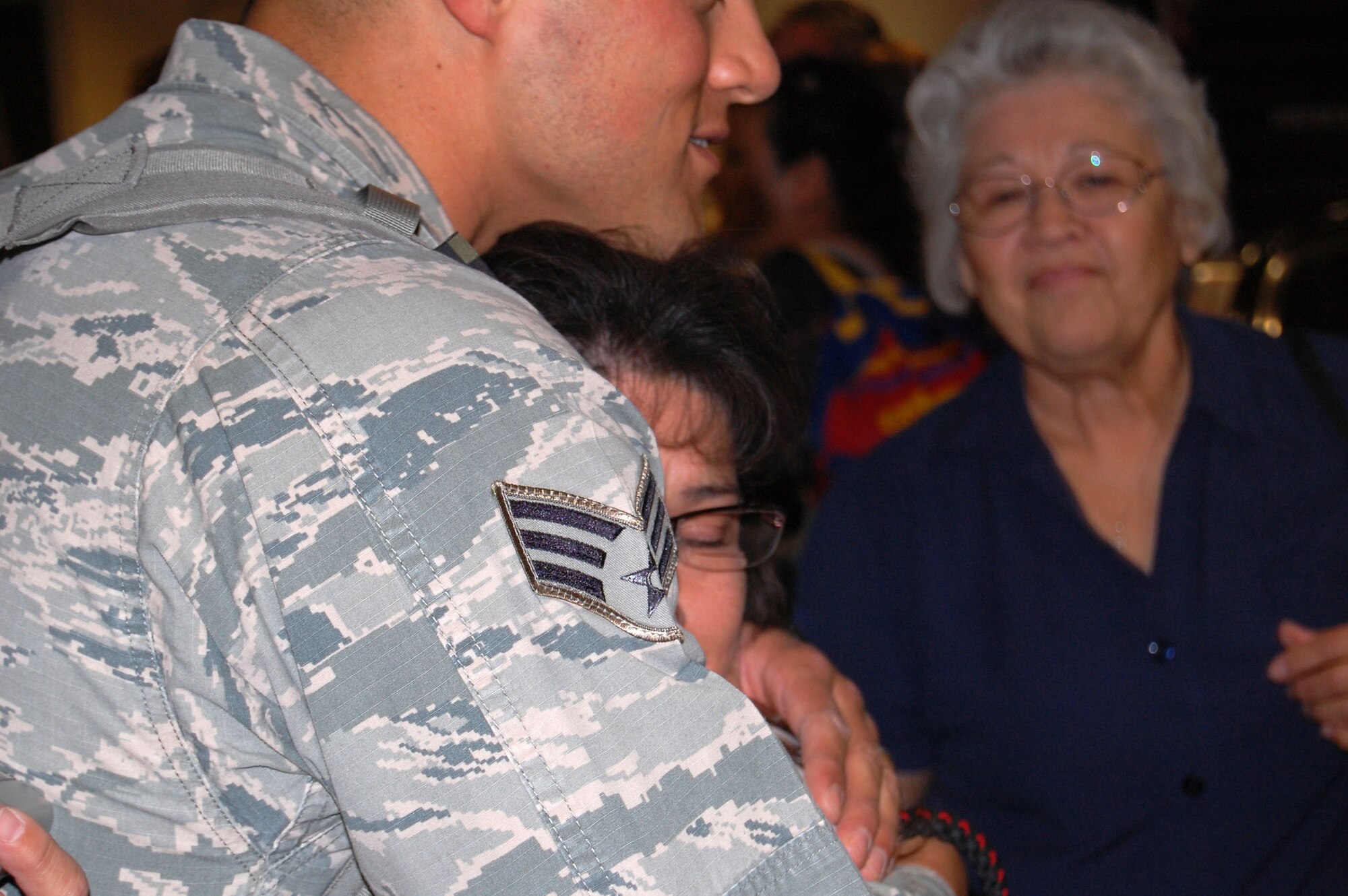 Senior Airman Frank Landavaso is greeted with a hug April 13 in the Tucson International Airport baggage claim. Landavaso and his fellow firefighters from the 162nd Fighter Wing spent the last six months deployed to Southwest Asia. (U.S. Air Force photo/Airman 1st Class Roberto Gonzalez)
