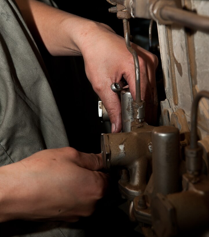 Airman 1st Class Alma Buenrostro, 28th Maintenance Squadron aerospace propulsion technician, removes bolts from an engine augmenter during routine maintenance at Ellsworth Air Force Base, S.D., March 21, 2012. The augmenter needed to be reassembled after the mixing duct was deemed unserviceable following an engine inspection. (U.S. Air Force photo by Airman 1st Class Alystria Maurer/Released)