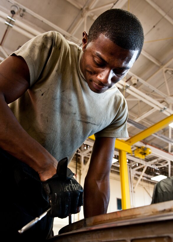 Senior Airman Kymric Walker, 28th Maintenance Squadron aerospace propulsion technician, takes apart the mixing duct on a B-1 engine during routine maintenance at Ellsworth Air Force Base, S.D., March 21, 2012. The mixing duct was deemed unserviceable during an engine inspection. (U.S. Air Force photo by Airman 1st Class Alystria Maurer/Released)