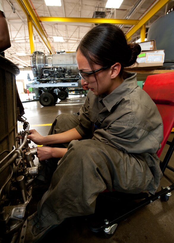 Airman 1st Class Alma Buenrostro, 28th Maintenance Squadron aerospace propulsion technician, removes bolts from a mixing duct during maintenance at Ellsworth Air Force Base, S.D., March 21, 2012. The propulsion shop was installing a mixing duct, flame holder, and augmenter fuel nozzles to make the engine serviceable. (U.S. Air Force photo by Airman 1st Class Alystria Maurer/Released)