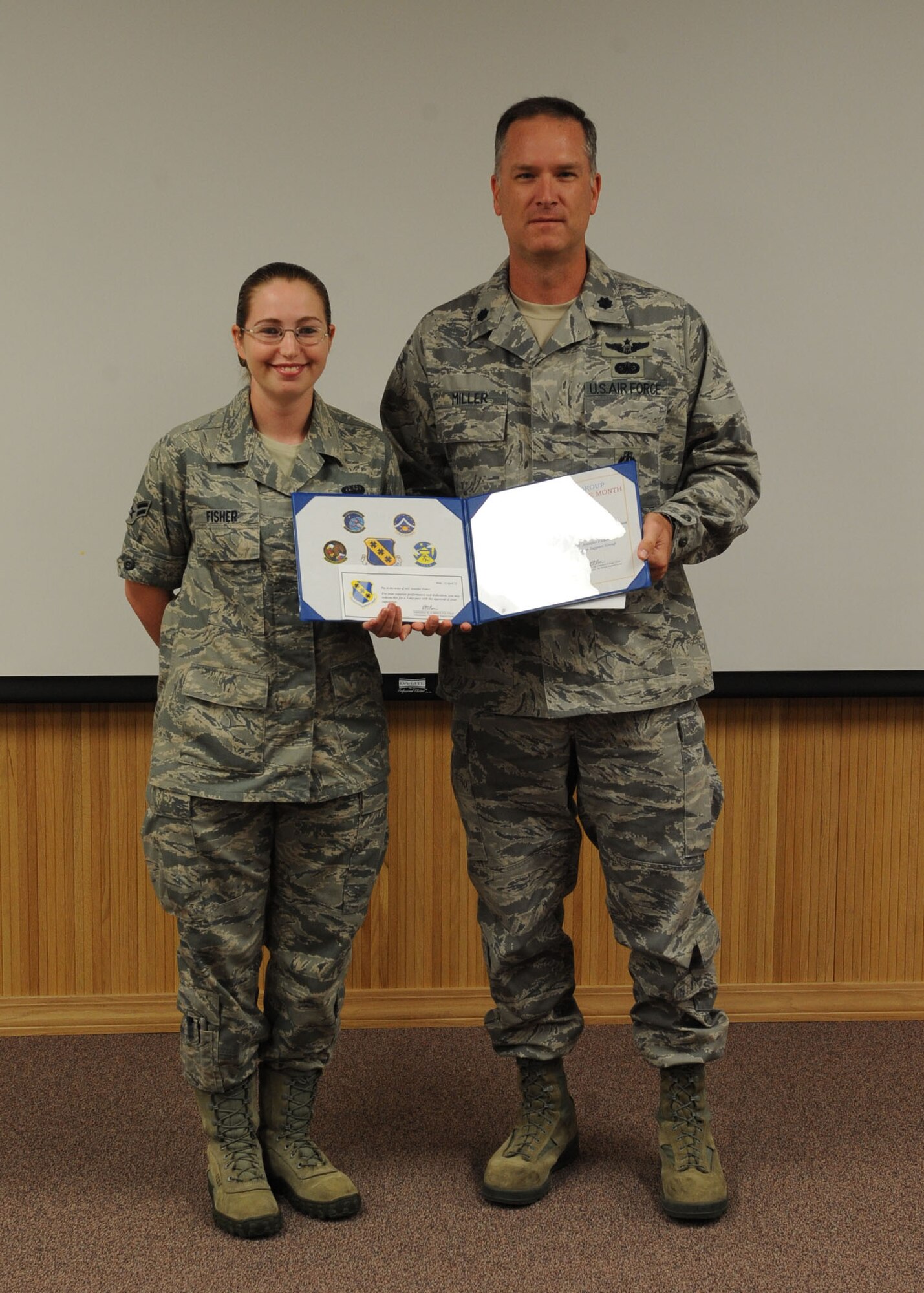 Airman 1st Class Jennifer Fisher, 7th Mission Support Group, receives the 7th MSG’s superior performer of the month award from Lt. Col. Michael Miller, 7th Mission Support Group deputy commander April 12, 2012, at Dyess Air Force Base, Texas. Fisher was recognized for her work on the correspondents tracking system and having the highest score in the 7th Bomb Wing for the staff assistance visit inspection. (U.S. Air Force photo by Airman 1st Class Peter Thompson/ Released)  