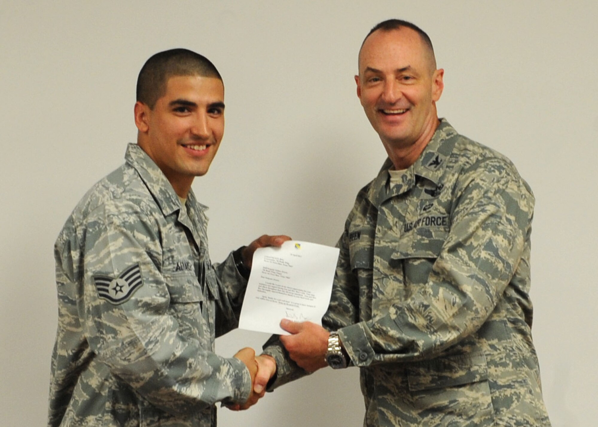 U.S. Air Force Staff Sgt. Joshua Alvarez, 7th Force Support Squadron, receives the 7th Bomb Wing’s superior performer of the month award from Col. David Béen, 7th Bomb Wing commander April 12, 2012, at Dyess Air Force Base, Texas. Alvarez was recognized for assisting protocol with Gen. Edward Rice Jr., Air Education and Training Command commander, visit to Dyess. (U.S. Air Force photo by Airman 1st Class Peter Thompson/ Released)