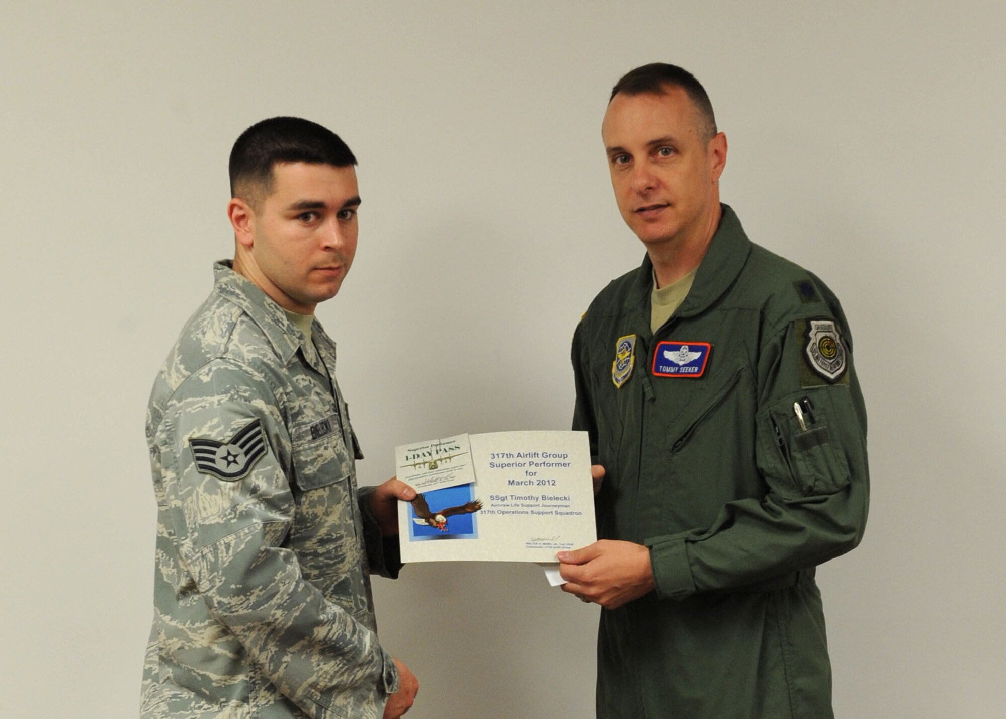 U.S. Air Force Staff Sgt. Tim Bielecki, 317th Airlift Group, receives the 317th AG’s superior performer of the month award from Lt. Col. Thomas Seeker 317th AG deputy commander April 12, 2012, at Dyess Air Force Base, Texas. Bielecki was recognized for reorganizing and cleaning the 317th Operation Support Squadron’s aircrew flight equipment shop which improved functionality. (U.S. Air Force photo by Airman 1st Class Peter Thompson/ Released)