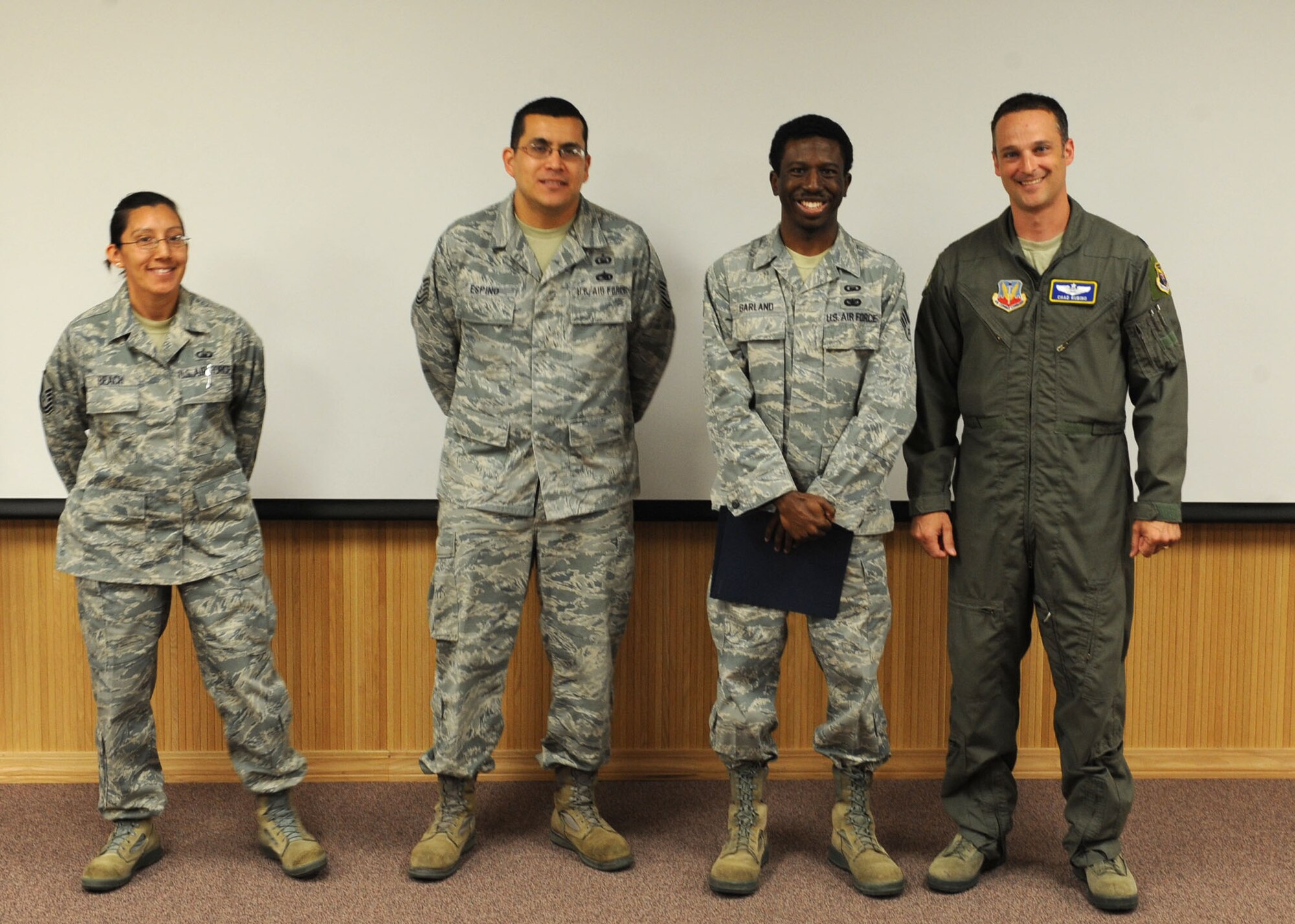 Airmen from the 7th Director of Staff chaplain corps team, receive the 7th DS’s superior performer of the month award from Lt. Col. Chad Rubino, 7th DS commander April 12, 2012, at Dyess Air Force Base, Texas. The chaplain corps team hosted traumatic stress response training and coordinated the visit of the Most Reverend Neal Buckon, Auxiliary Bishop for the Archdiocese for the Military Services. (U.S. Air Force photo by Airman 1st Class Peter Thompson/ Released)  