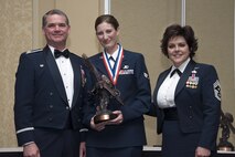 Senior Airman Jessica Deylius, an aircrew flight equipment journeyman with the 302nd Operations Support Squadron is presented with the 302nd Airlift Wing 2011 Airman of the Year Award by Col. Jay Pittman, Commander of the 302nd AW and Chief Master Sgt. Suzette Cherry, Command Chief Master Sgt. of the 302nd AW during the Wing’s Annual Award Banquet held during the March Unit Training Assembly. (USAF photo/Craig Denton)