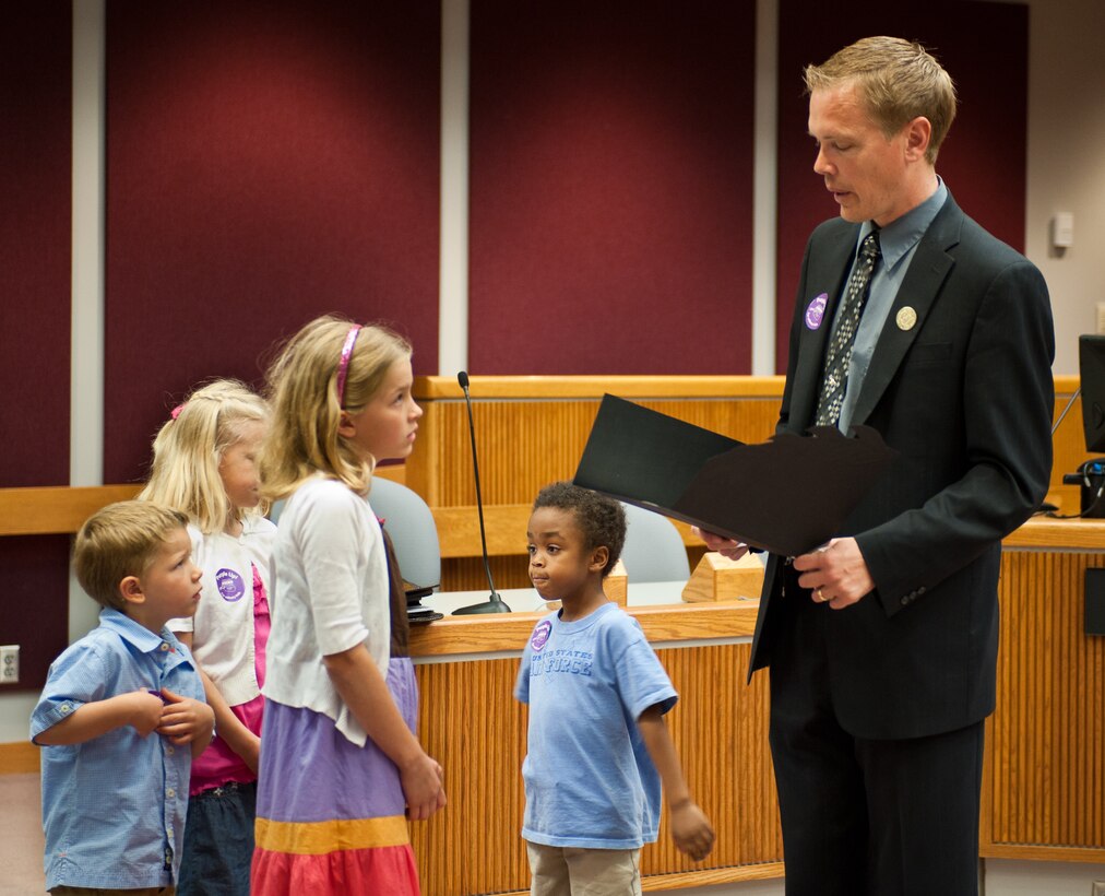 Sam Kooiker, mayor of Rapid City, proclaims April 13th “Purple Up for Military Kids” Day in Rapid City on April 12, 2012. The Operation Military Kids program organized this event to honor the sacrifices of military kids nationwide by wearing purple on April 13th. (U.S. Air Force photo by Airman 1st Class Alystria Maurer/Released)