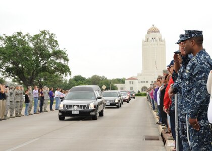 Joint Base San Antonio members salute the hearse carrying the body of Seaman
Trevor J. Stanley, of Virginia Beach, Va., April 13 at JBSA-Randolph.
Stanley was assigned to Naval Mobile Construction Battalion 3, Port Hueneme,
Calif. The motorcade exited Randolph for funeral services at Colonial
Funeral Home in Universal City. Stanley's family resides in the area. 
(U.S. Air Force photo by Melissa Peterson)