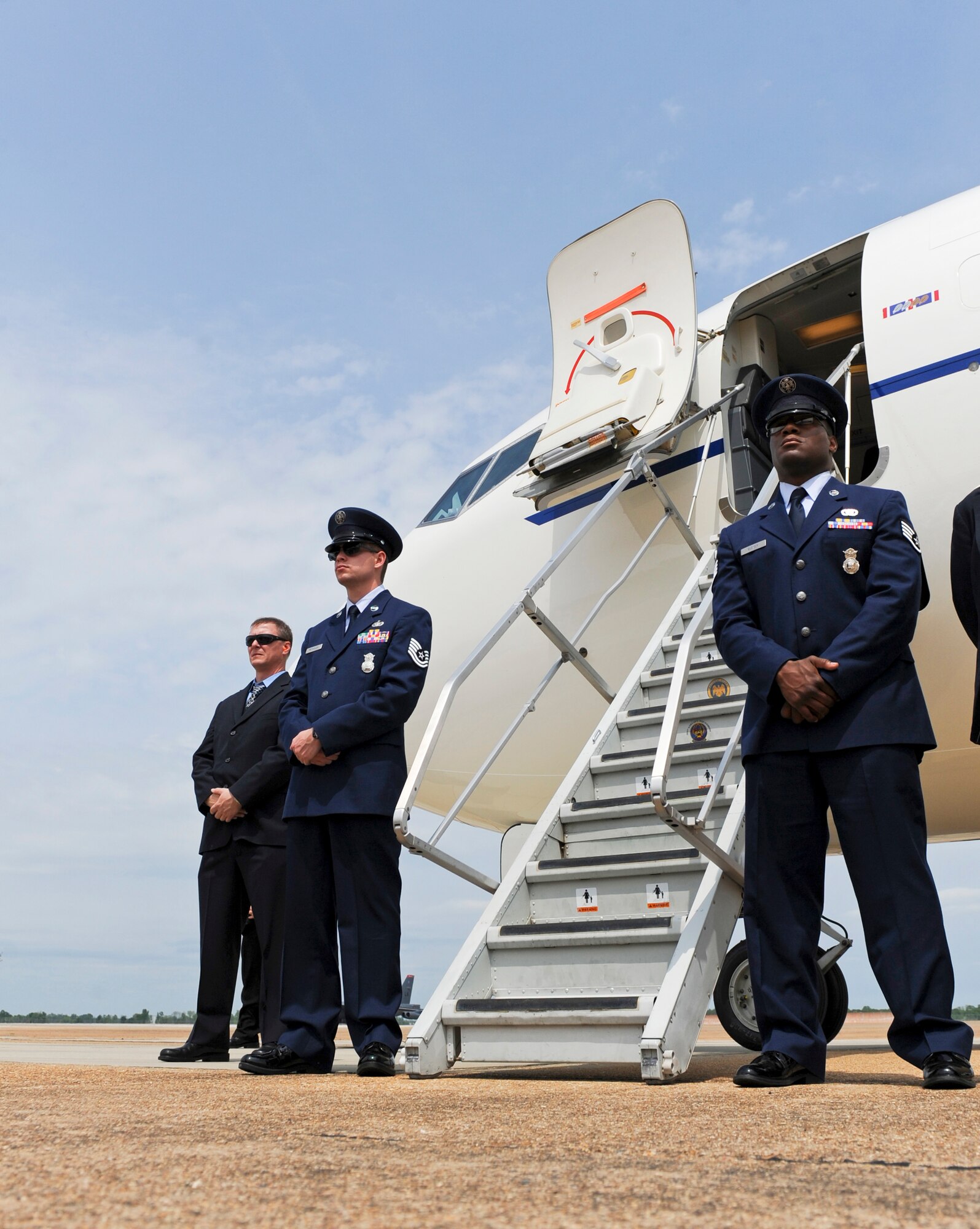 Airmen and support personnel stand by for the arrival of Michelle Obama on Barksdale Air Force Base, La., April 12. The First Lady visited the local area to celebrate the first anniversary of the Joining Forces Campaign. The campaign was established to encourage employers to hire military veterans and their spouses. (U.S. Air Force photo/Airman 1st Class Micaiah Anthony)(RELEASED)