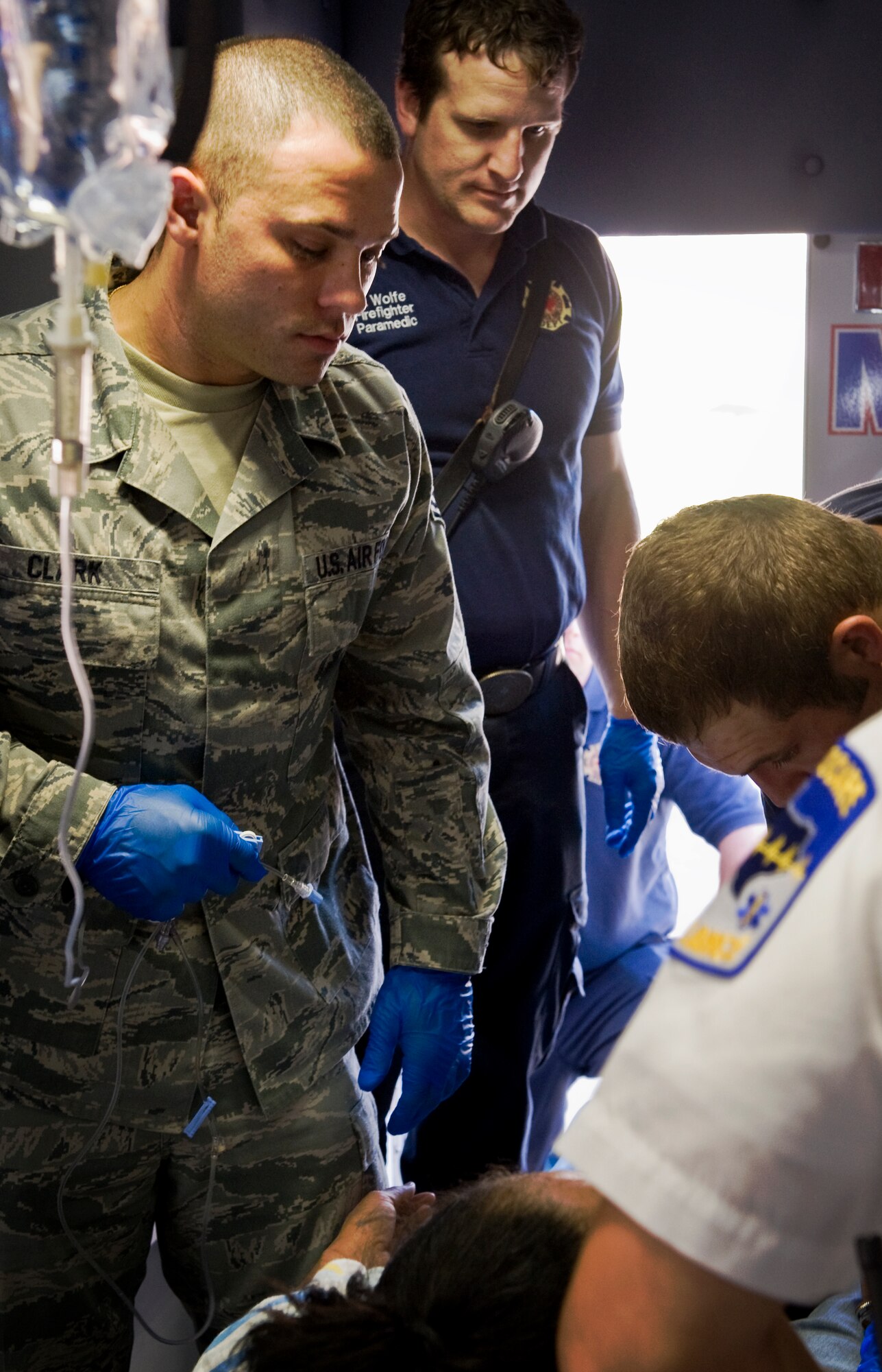 Senior Airman Jordan Clark, 7th Aerospace Medicine Squadron, readies an intravenous solution April 2, 2012, during training with Abilene MetroCare, in Abilene, Texas. The program allows Airmen from the 7th Medical Group to partner with MetroCare paramedics to receive additional first-responder training (U.S. Air Force photo by Airman 1st Class Jonathan Stefanko/ Released)
