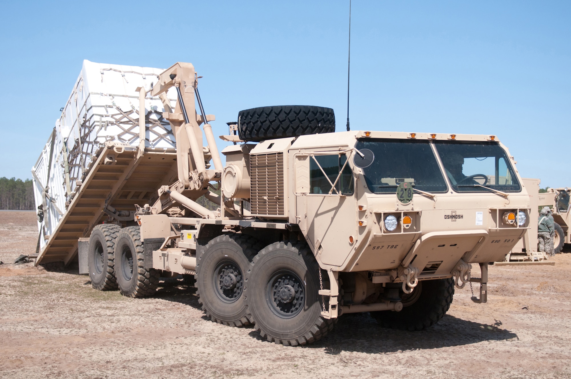 A U.S. Army Soldier from the 690th Rapid Port Opening Element loads a cargo container onto an M11-20 Heavy Expanded Mobility Tactical Truck in the marshaling yard at Lakehurst Naval Air Engineering Station, N.J., March 27, 2012. The cargo, which arrived by airlift earlier in the week, is being transported over land to a forward distribution node as part of a U.S. Transportation Command exercise designed to test the ability of the Kentucky Air National Guard’s 123rd Contingency Response Group to establish a Joint Task Force-Port Opening within 24 hours of arrival. (U.S. Air Force photo by Master Sgt. Phil Speck)