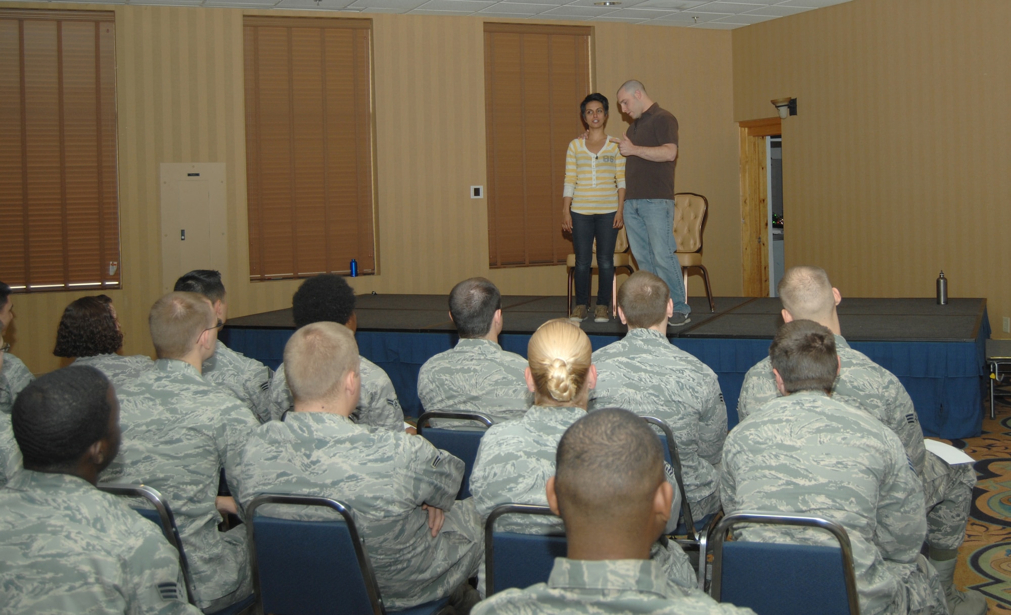 Fawzia Mirza and George Zerante, Sex Signals actors, perform in front of Airmen at the Mirage Club on Davis-Monthan Air Force Base, Ariz., April 10. Sex Signals is an improvised, two-person presentation geared to educate Airmen about the stereotypes and misconceptions surrounding sexual assault. (U.S. Air Force photo by Airman 1st Class Michael Washburn/Released)