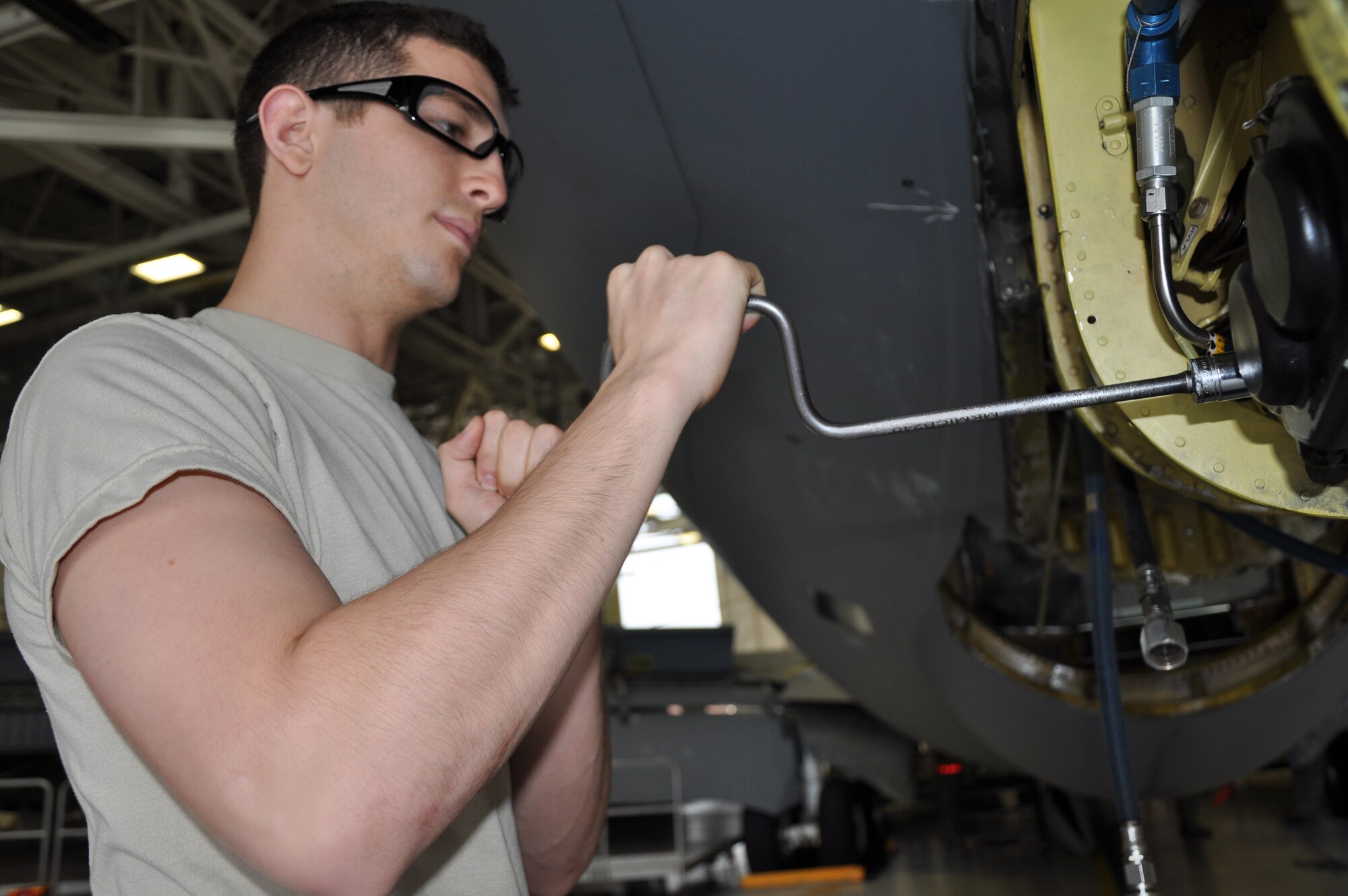MCCONNEL AIR FORCE BASE, Kan, -- Airman First Class Zach Buccieri a backshop hydraulics specialits, 22nd Maintenance Squadron, uses a crank to manually extend the boom on a KC-135 Stratotanker. The integrated total force initiative Hyrdraulics Section of the 931st Maintenance Squadron and the 22nd MXS, repair and maintain hydraulic equipment for all KC-135 Stratotankers here. Hydraulic components are a vital part of achieving flight and safe landing. The landing gears, flaps, spoilers, and the boom are all operated with hydraulic equipment. (Air Force photo by Staff Sgt. Carrie Peasinger)