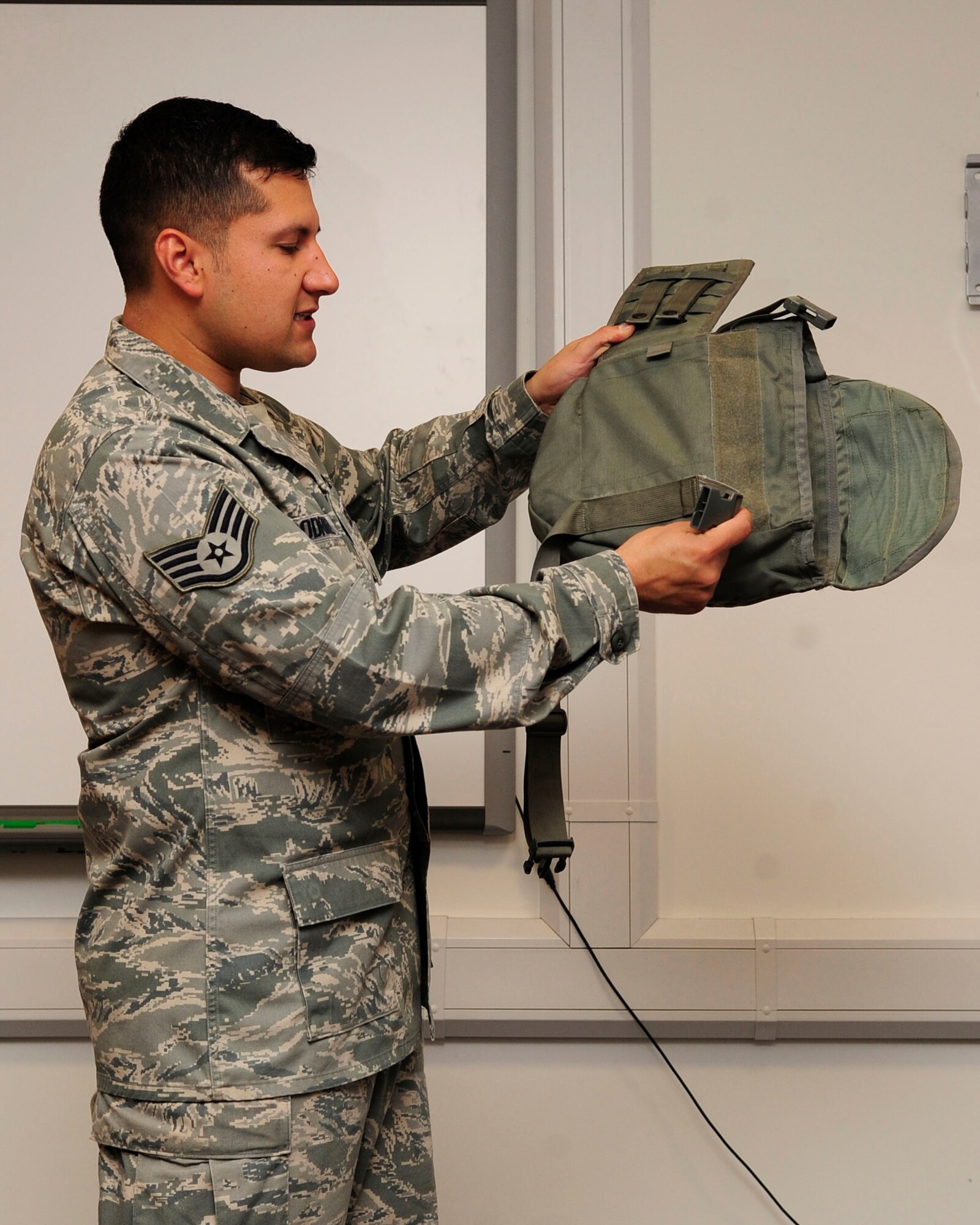 RAF MILDENHALL, England - Staff Sgt. David Rodriguez, 100th Civil Engineer Squadron, demonstrates how to properly store a gas mask during a Chemical, Biological, Radiological and Nuclear training class here April 12, 2012. Currently, the 100th CES has seven qualified CBRN instructors and holds an average of seven classes per month. (U.S. Air Force photo/Senior Airman Ethan Morgan) 