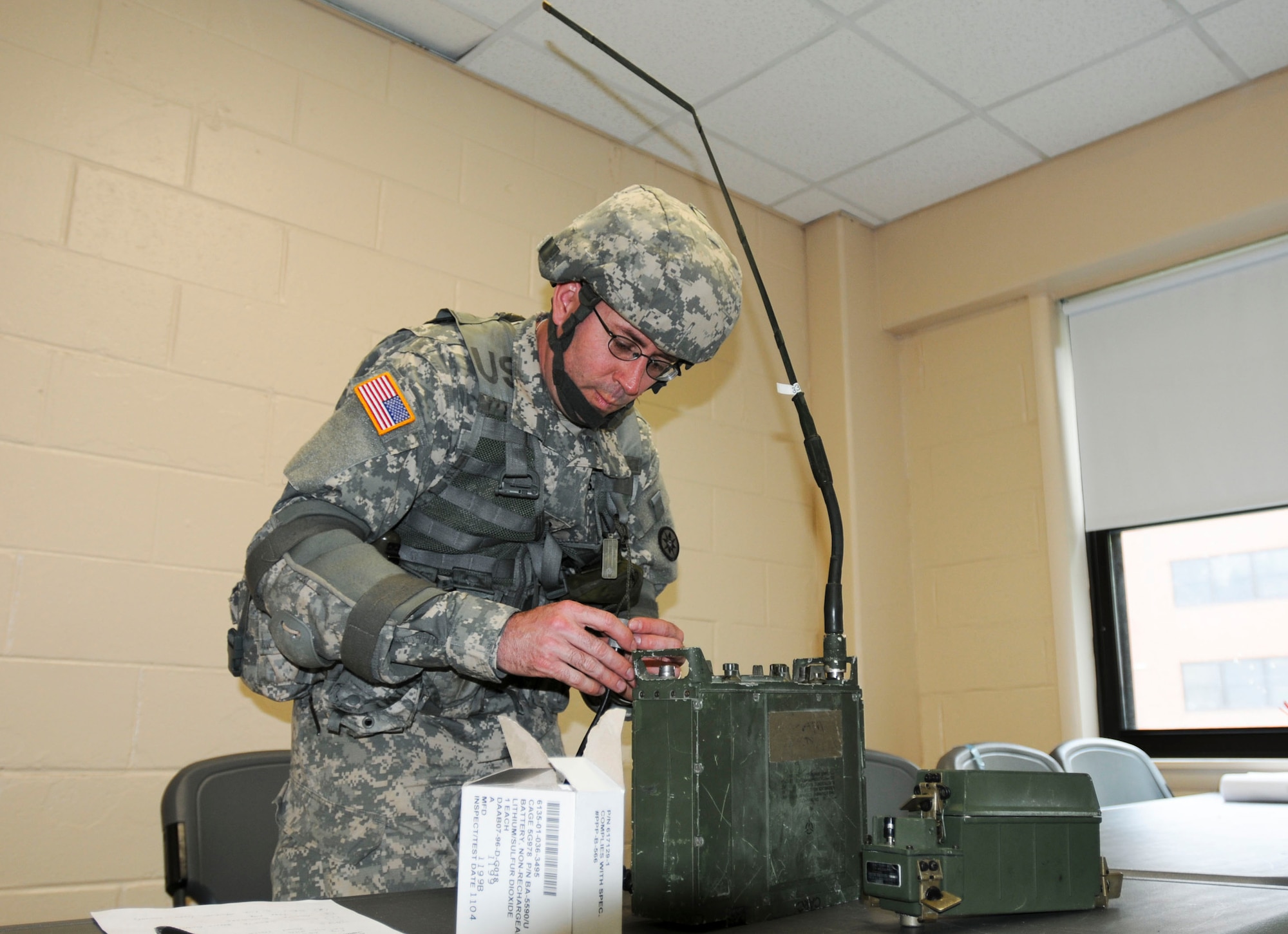 Spc. Christopher P. Fitt, 439th Quartermaster Company, programs a Single Channel Ground to Air Radio during an Army Warrior Task at the 316th Expeditionary Sustainment Command 2012 Best Warrior competition. Fitt won the "Soldier of the Year." (U.S. Army courtesy photo/Released)