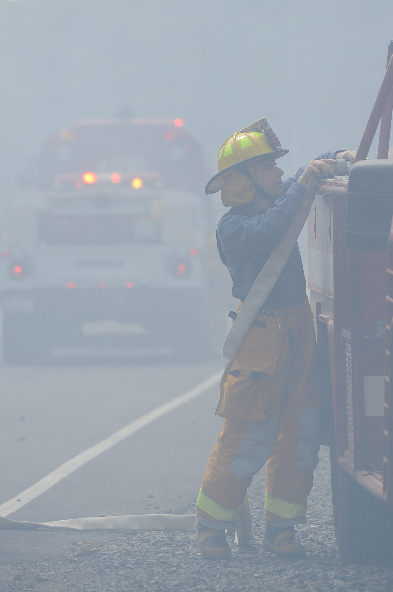 A Chesterfield firefighter connects a fire hose to a fire truck near training ranges 13 and 14 on Joint Base McGuire-Dix-Lakehurst April 9. More than 10 townships from around the joint base aided the effort to extinguish the fire that burned more than 300 acres of training ranges. (U.S. Air Force photo by Russ Meseroll/Released)