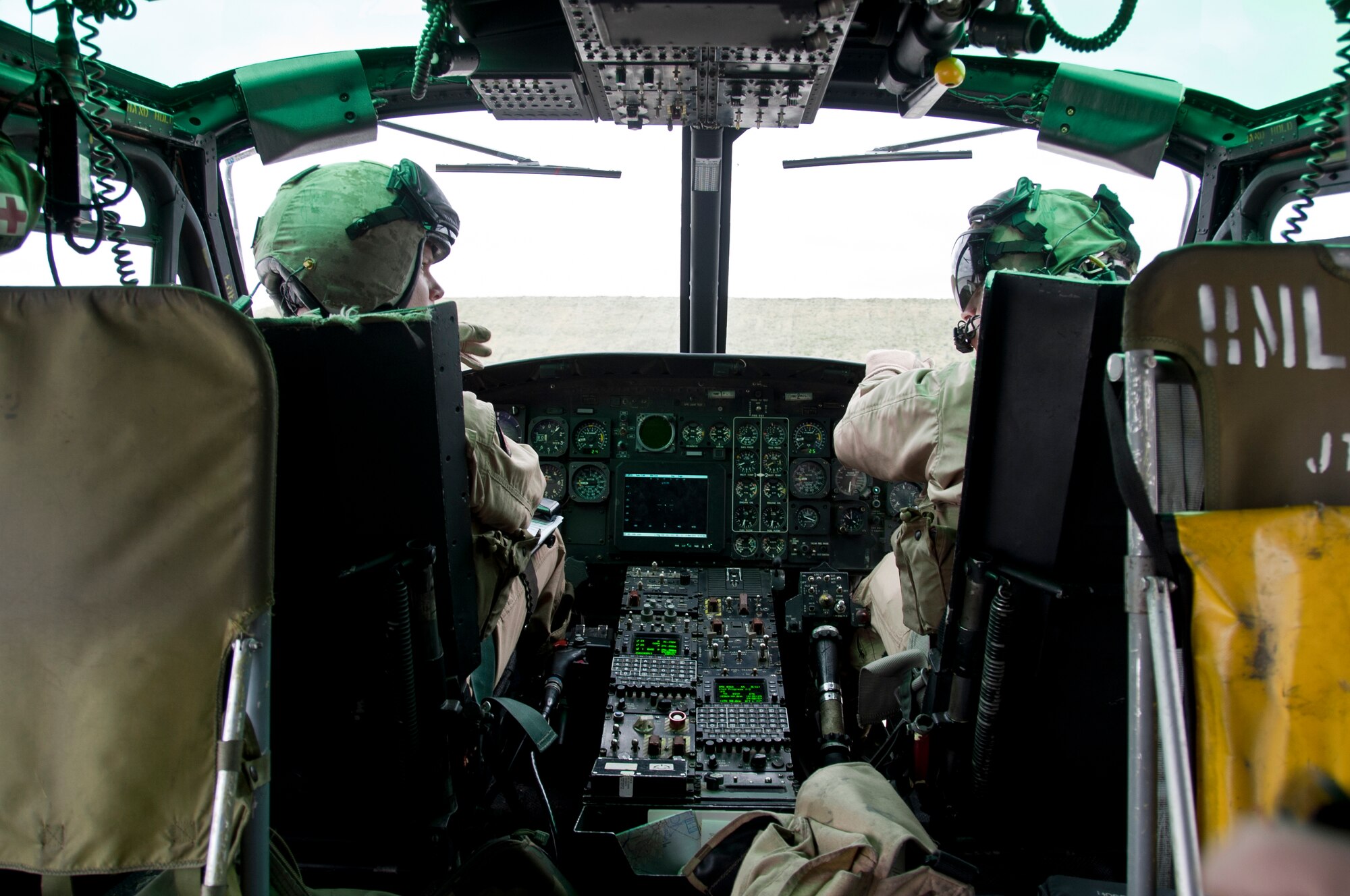 From left, Capt. Danny Byrd, UH-1N Iroquois co-pilot, and Lt. Col. Rollin Russell, UH-1N pilot, discuss flight plans prior to take off March 21. Byrd and Russell are Marines assigned to Marine Helicopter Light Attack 773.  (U.S. Air Force photo by Staff Sgt. David Carbajal/Released)