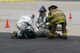 Airmen from the 139th Fire Department and a firefighter from the St. Joseph Fire Department assist a role-player posing as a victim during a major accident response exercise (MARE) at Rosecrans Memorial Airport, St. Joseph, Mo., April 12, 2012. The MARE tested Air National Guard and civilian agencies in their ability to respond to an aircraft accident. (U.S. Air Force photo by Staff Sgt. Michael Crane/Missouri Air National Guard)