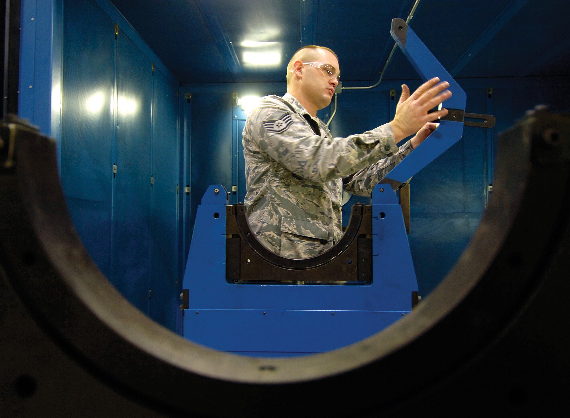 Staff Sgt. David Crouse, a jet engine mechanic in the F117 shop of Bldg. 3001, sets up a balance machine to test a low pressure turbine.  The machine tests various sections of the engine, including the low pressure compressor.  Sgt. Crouse is the first military mechanic here certified to balance the low pressure compressor and is working toward getting his certification on the other engine sections.  The F117 powers the C-17 aircraft and is maintained at Tinker by members of the 545th Propulsion Maintenance Squadron. (Air Force photo by Margo Wright)