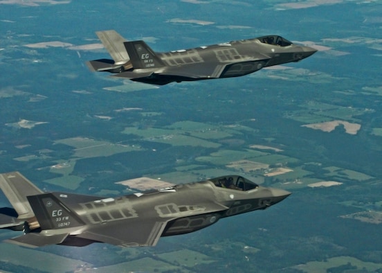 Two F-35A Lightning IIs from the 33rd Fighter Wing soar over the Eglin Air Force Base, Fla., range during the unit’s first joint strike fighter formation flight April 10, 2012. Lt. Col. Eric Smith, 58th Fighter Squadron director of operations, flew the lead aircraft while Marine Maj. Joseph Bachmann, Fighter Attack Training Squadron 501 aircraft maintenance officer, flew wingman. The pilots, both first in their service qualified to fly the fifth generation aircraft, were validating pilot syllabus objectives in preparation for future training. The 33 FW is responsible for F-35 A/B/C pilot and maintainer training for the Marine Corps, Navy, Air Force, and in the future, at least eight coalition partners. (U.S. Air Force photo/Capt. Ryan Seymour) 