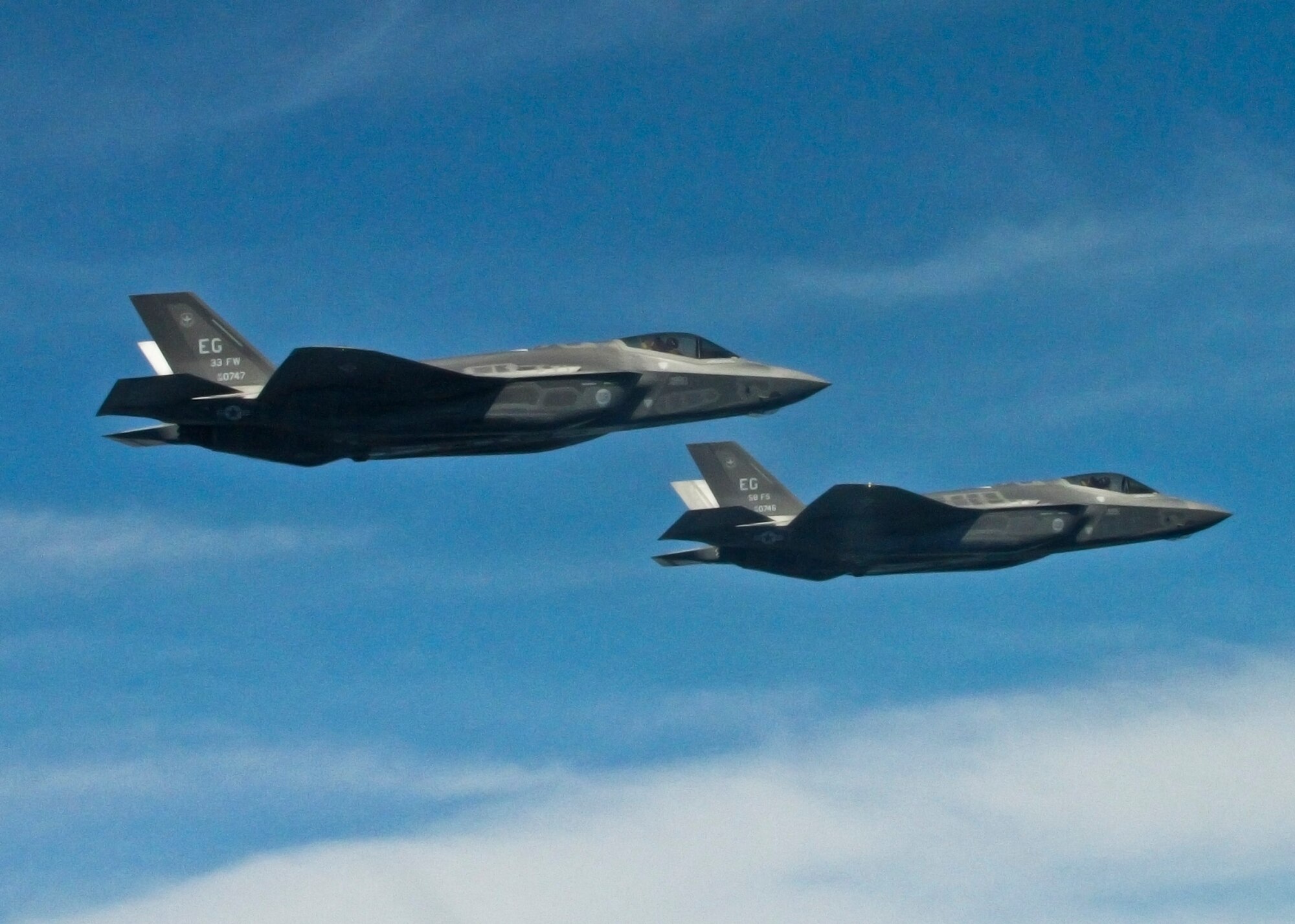 Two F-35A Lightning IIs from the 33rd Fighter Wing soar over Eglin Air Force Base's range during the unit’s first joint strike fighter formation flight April 10. Lt. Col. Eric Smith, 58th Fighter Squadron director of operations, flew the lead aircraft while Marine Maj Joseph Bachmann, Fighter Attack Training Squadron 501 aircraft maintenance officer, flew wingman. The pilots, both first in their service qualified to fly the 5th generation aircraft, were validating pilot syllabus objectives in preparation for future training. The 33rd FW is responsible for F-35 A/B/C pilot and maintainer training for the Marine Corps, Navy, Air Force, and in the future, at least eight coalition partners. (U.S. Air Force photo/Capt. Ryan Seymour) 
