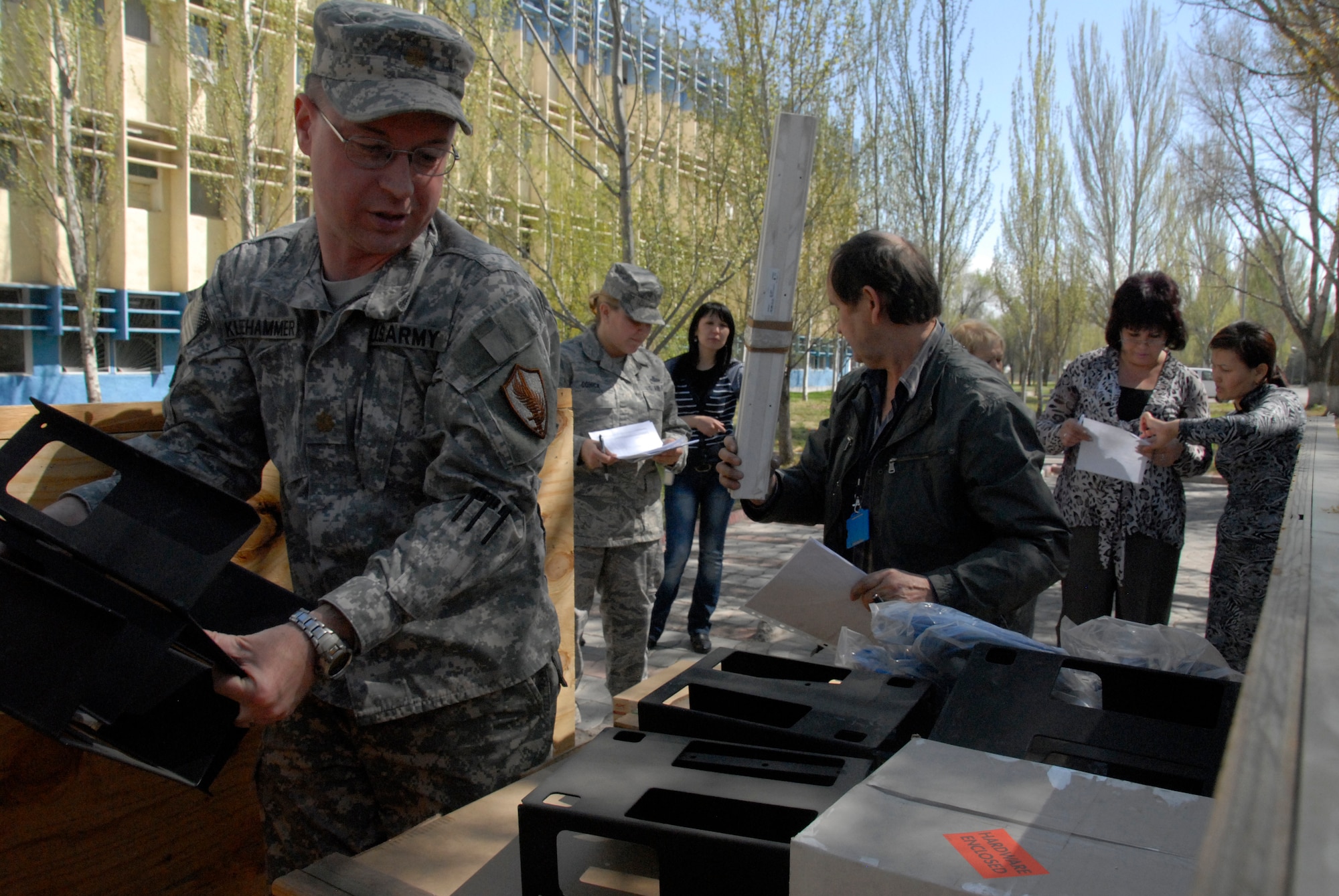 Maj. Joel Kleehammer, U.S. Embassy chief of office of military cooperation, unloads equipment for an English language lab at Manas International Airport, Kyrgyzstan, April 11, 2012. The delivery included 10 student computer systems that will link together with one instructor computer. (U.S. Air Force photo/Senior Airman Lynsie Nichols)