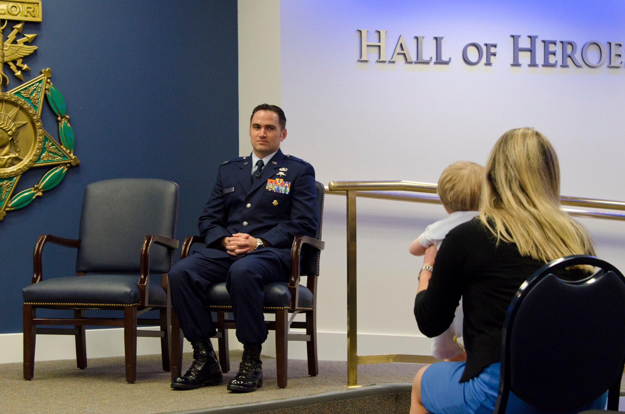 Captain Barry F. Crawford, Jr. from the Maryland Air National Guard, 175th Wing is watching his son and wife while waiting to be awarded the Air Force Cross and Purple Heart today at a ceremony hosted by Air Force Chief of Staff General Norton Schwartz at the Pentagon's Hall of Heroes, April 12, 2012. He was awarded the above medals for his extraordinary heroism in military operations against an armed enemy of the United States as Special Tactics Officer near Lagham Province, Afghanistan, on May 4, 2010. Captain Crawford is credited for taking decisive action to save the lives of three wounded Afghan soldiers and evacuate two Afghan soldiers killed in action. Captain Crawford is fifth recipient since 9/11 to receive the Air Force Cross. (National Guard photo by Master Sgt. Ed Bard)