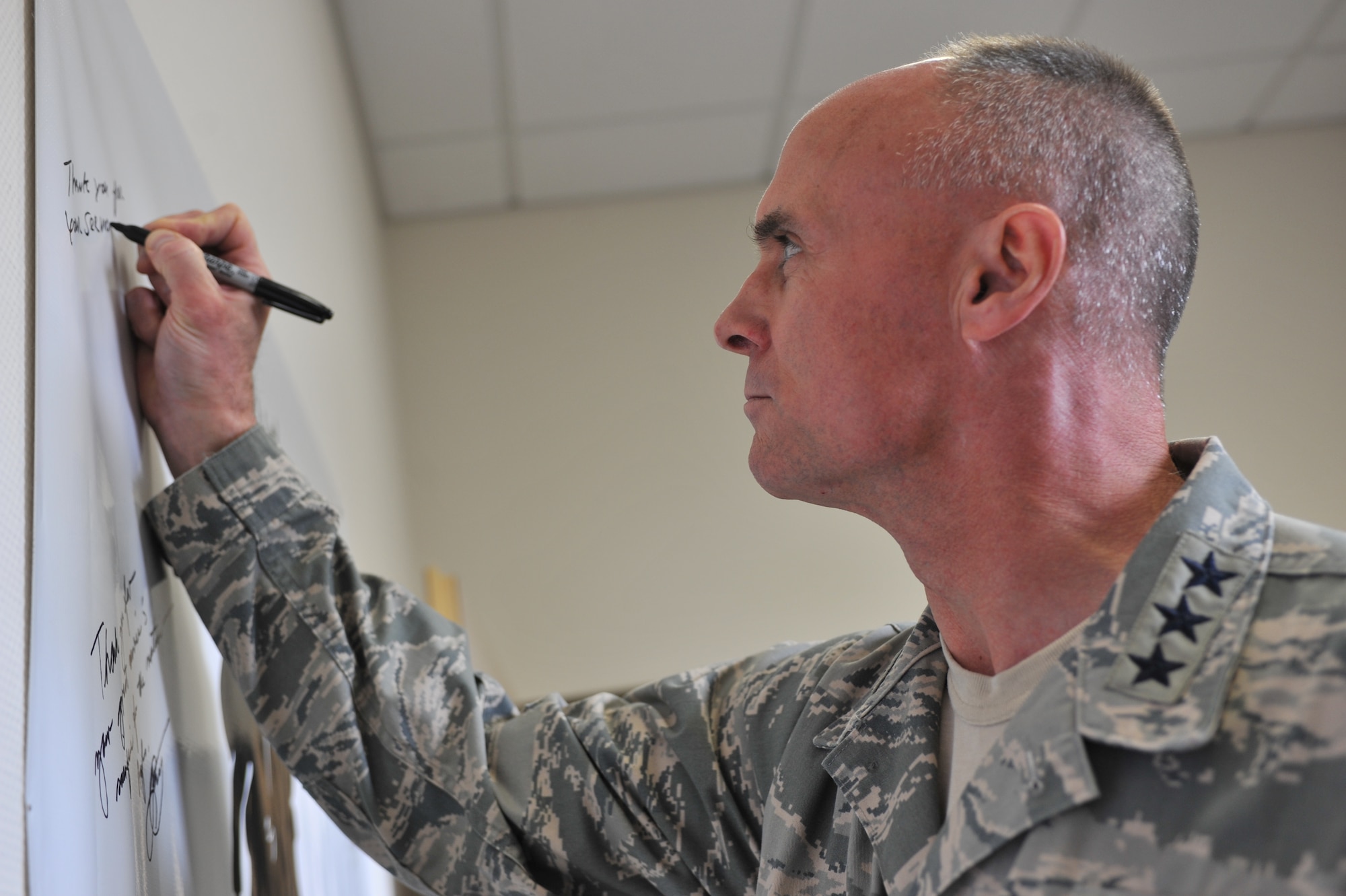 Lt. Gen. Craig Franklin, 3rd Air Force commander, signs a wounded warrior banner at the Contingency Aeromedical Staging Facility at Ramstein Air Base, Germany, April 11, 2012. During the visit, Franklin expressed his appreciation for the dedication and hard work of the service members who ensure wounded warriors receive world-class care.  (U.S. Air Force photo/ Airman 1st Class Caitlin O'Neil-McKeown)

