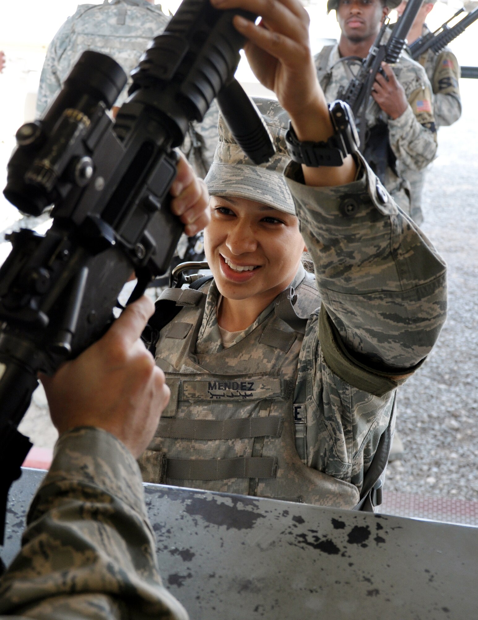 Airman 1st Class Ana Mendez, 387th Expeditionary Security Forces Squadron Response Force member, turns in her weapon at the end of shift Apr. 7, 2012, at an undisclosed location in Southwest Asia.  Mendez is deployed from the 11th Security Forces Squadron, Andrews Air Force Base, Md.  (U.S. Air Force photo/Tech. Sgt. Stacy Fowler)