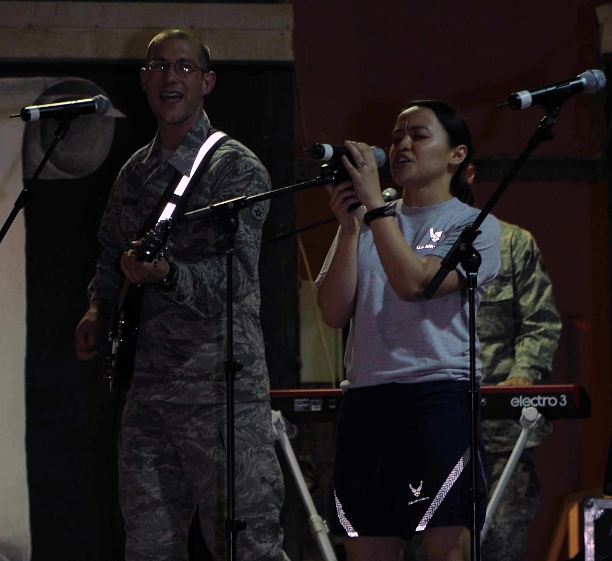 SOUTHWEST ASIA - Capt. Theresa Sheehan belts out Lady Gaga?s song ?You and I? during a concert April 9, 2012, as part of the U.S. Air Forces Central Band Night Wing?s visit to the 380th Air Expeditionary Wing. The band invited several members of the wing to perform alongside them. The captain is deployed from Tinker Air Force Base, Okla., to the 964th Expeditionary Airborne Air Control Squadron. (U.S. Air Force photo/Staff Sgt. J.G. Buzanowski)