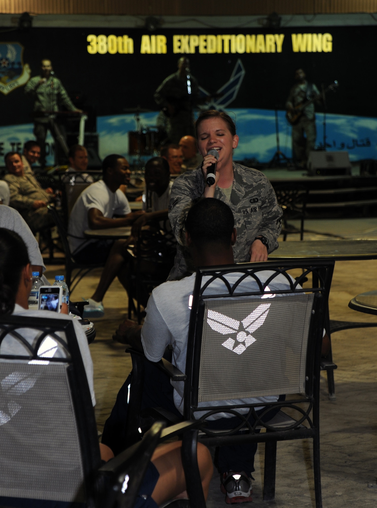 SOUTHWEST ASIA - Airman 1st Class Melissa Rager, the lead singer for the U.S. Air Forces Central Band, Night Wing, serenades members of the audience during a concert for the 380th Air Expeditionary Wing April 9, 2012. The seven members of Night Wing are deployed from Offutt Air Force Base, Neb., and will spend the majority of their deployment traveling to bases around the U.S. Central Command area of responsibility. (U.S. Air Force photo/Staff Sgt. J.G. Buzanowski)