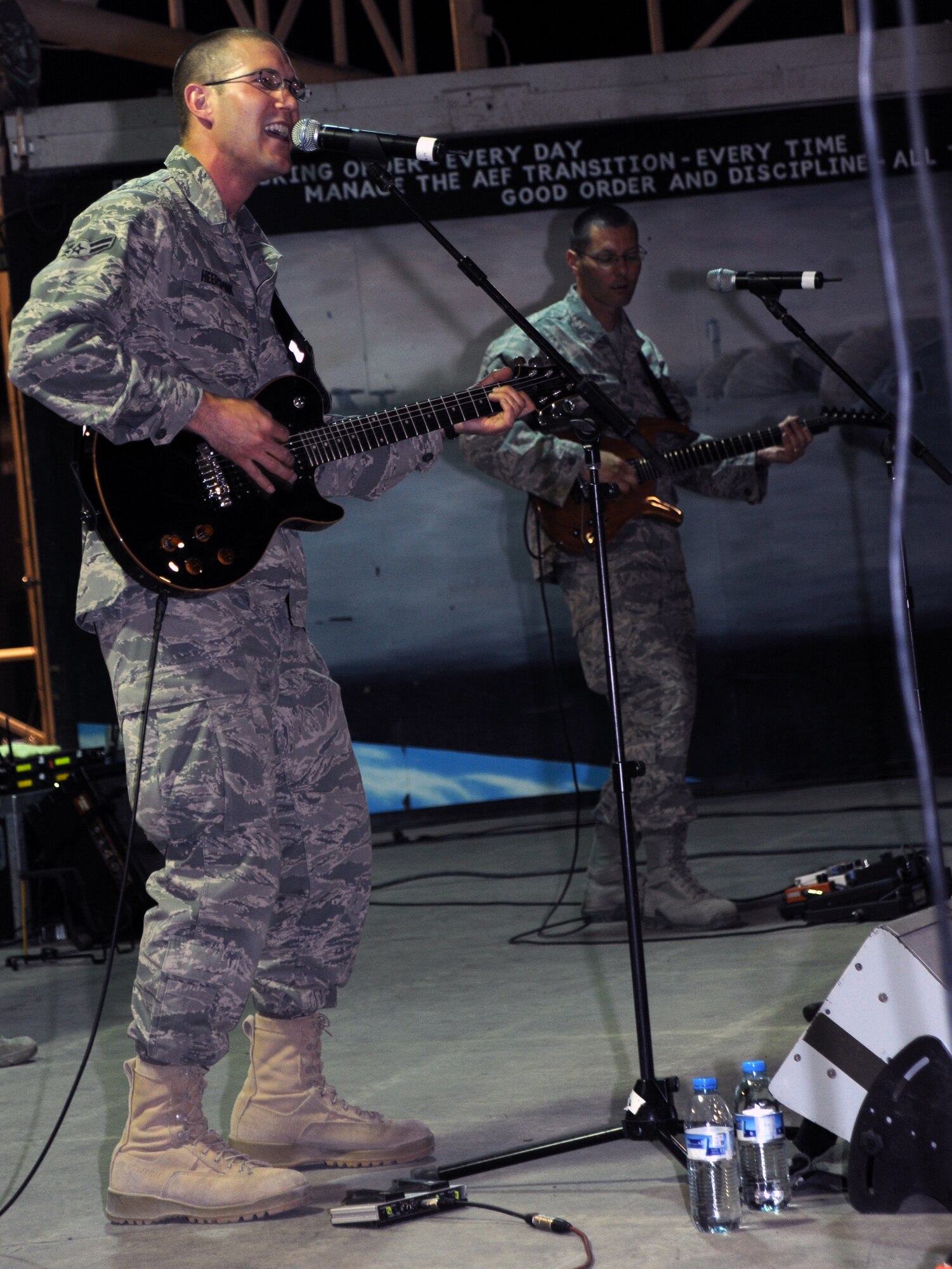 SOUTHWEST ASIA - U.S. Air Forces Central Band guitarists Airman 1st Class Lee Heerspink and Master Sgt. Richard Baisden perform for members of the 380th Air Expeditionary Wing April 9, 2012. The AFCENT band Night Wing played several shows for people on base as well as for students at a local university. (U.S. Air Force photo/Staff Sgt. J.G. Buzanowski)