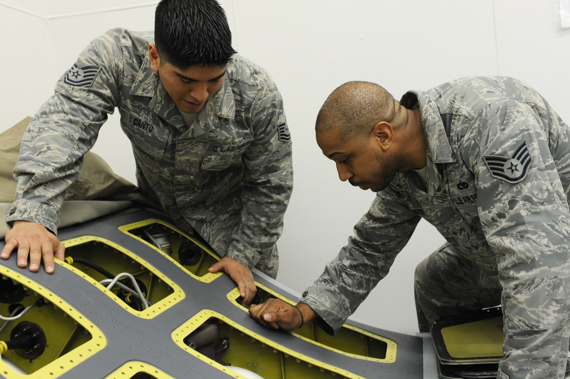 U.S. Air Force Tech. Sgt. Luis Cantu, left, 372nd Training Squadron Detachment 23 fuels systems and hydrogen instructor, shows Staff Sgt. Josiah Garth, 35th Maintenance Operations Squadron maintenance trainer flight propulsion instructor, an engine feed system at Misawa Air Base, Japan, April 10, 2012. The engine feed system ensures a stable fuel flow and prevents an imbalance in the aircraft. (U.S. Air Force photo by Airman 1st Class Kia Atkins/Released)