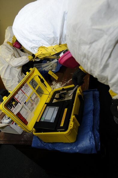 ANDERSEN AIR FORCE BASE, Guam – Airmen from the 36th Civil Engineer Squadron bio-environmental and hazardous materials test a powder chemical during an exercise April 12. The analyzer they are using will provide a basic identification of the substance to give insight into what kind of tests need to be preformed. (U.S. Air Force photo/Senior Airman Carlin Leslie)