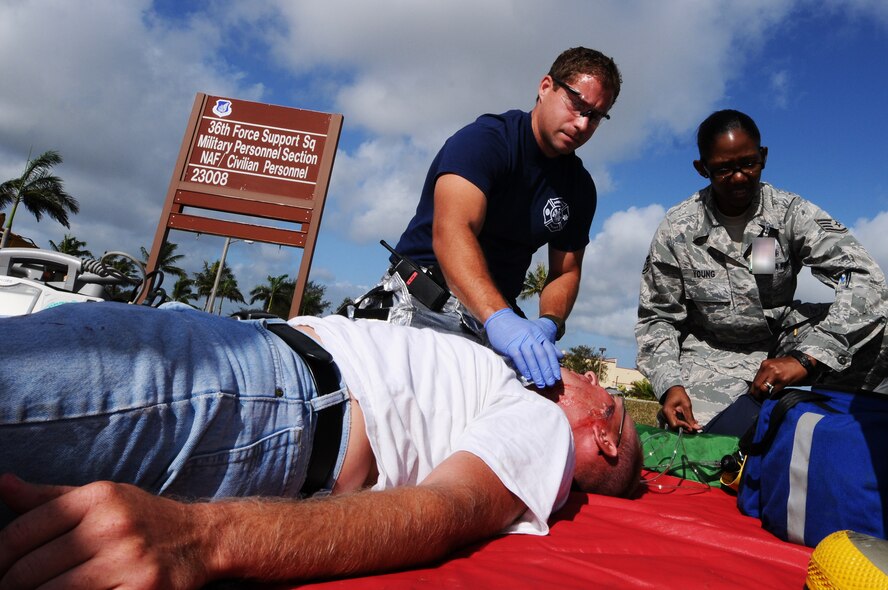 ANDERSEN AIR FORCE BASE, Guam -   Eric Masur, 36th Civil Engineer Squadron fire and emergency services crew chief (left), and Staff Sgt. Johnetta Young of the 36th Medical Operations Squadron, provide medical care to a role player during an exercise April 12. The exercise tests and evaluates the emergency response to incidents that may occur on base. (U.S. Air Force photo by Senior Airman Carlin Leslie)