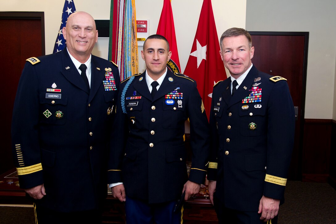 Army Chief of Staff Gen. Raymond T. Odierno, left, and Army Maj. Gen. James C. McConville, right, stand next to Army Sgt. Felipe Pereira before his presentation of the Distinguished Service Cross at McAuliffe Hall on Fort Campbell, Ky., April 12, 2012. McConville is the commanding general of the 101st Airborne Division.