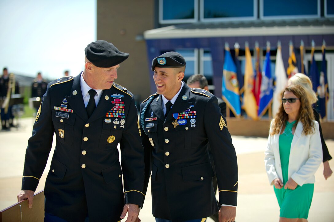 Army Command Sgt. Maj. Scott C. Schroeder, left, shares a joke with Army Sgt. Felipe Pereira after he received the Distinguished Service Cross at McAuliffe Hall on Fort Campbell, Ky., April 12, 2012. Schroeder is the 101st Airborne Division's command sergeant major.