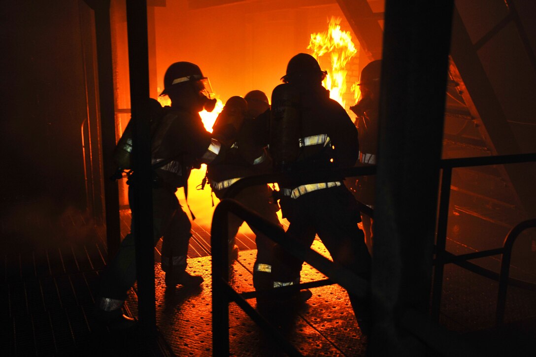 U.S. Navy sailors practice shipboard firefighting during an advanced damage control class at the Yokosuka Center for Naval Engineering Firefighting School at Commander Fleet Activities Yokosuka, April 12, 2012. The sailors are assigned to the aircraft carrier USS George Washington.