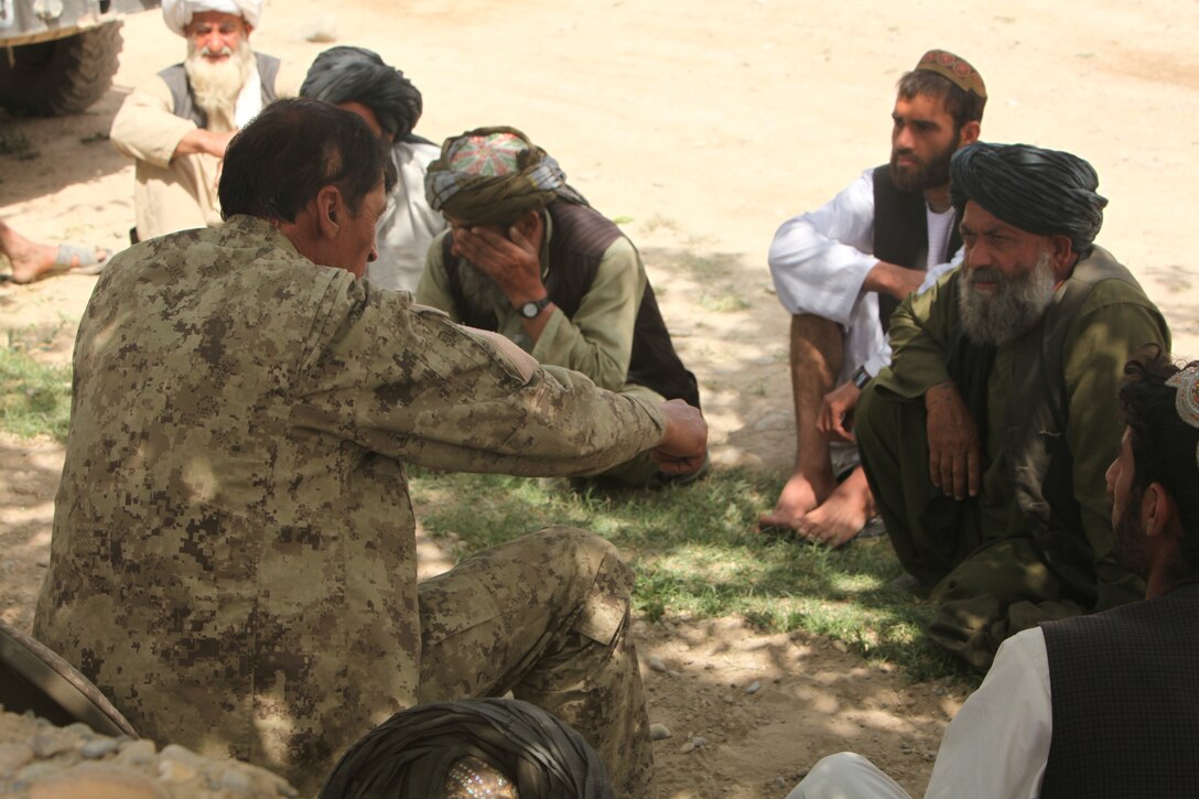 Major Muhammad Razim Waziri, a company commander of the Afghan National Civil Order Police at Patrol Base Virginia, talks to village elders during a shura here, April 14, 2012. During the shura, members of the community had the chance to talk directly to Marine and ANCOP leaders about any issues or security concerns in the community. (U.S. Marine Corps photo by Lance Cpl. Tyler Reiriz)
